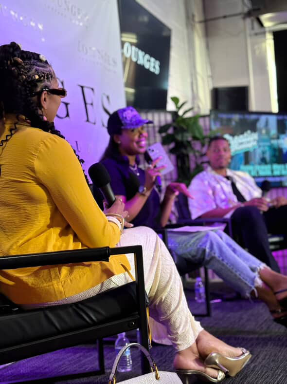 Nikki B moderating a panel discussion at Lounges