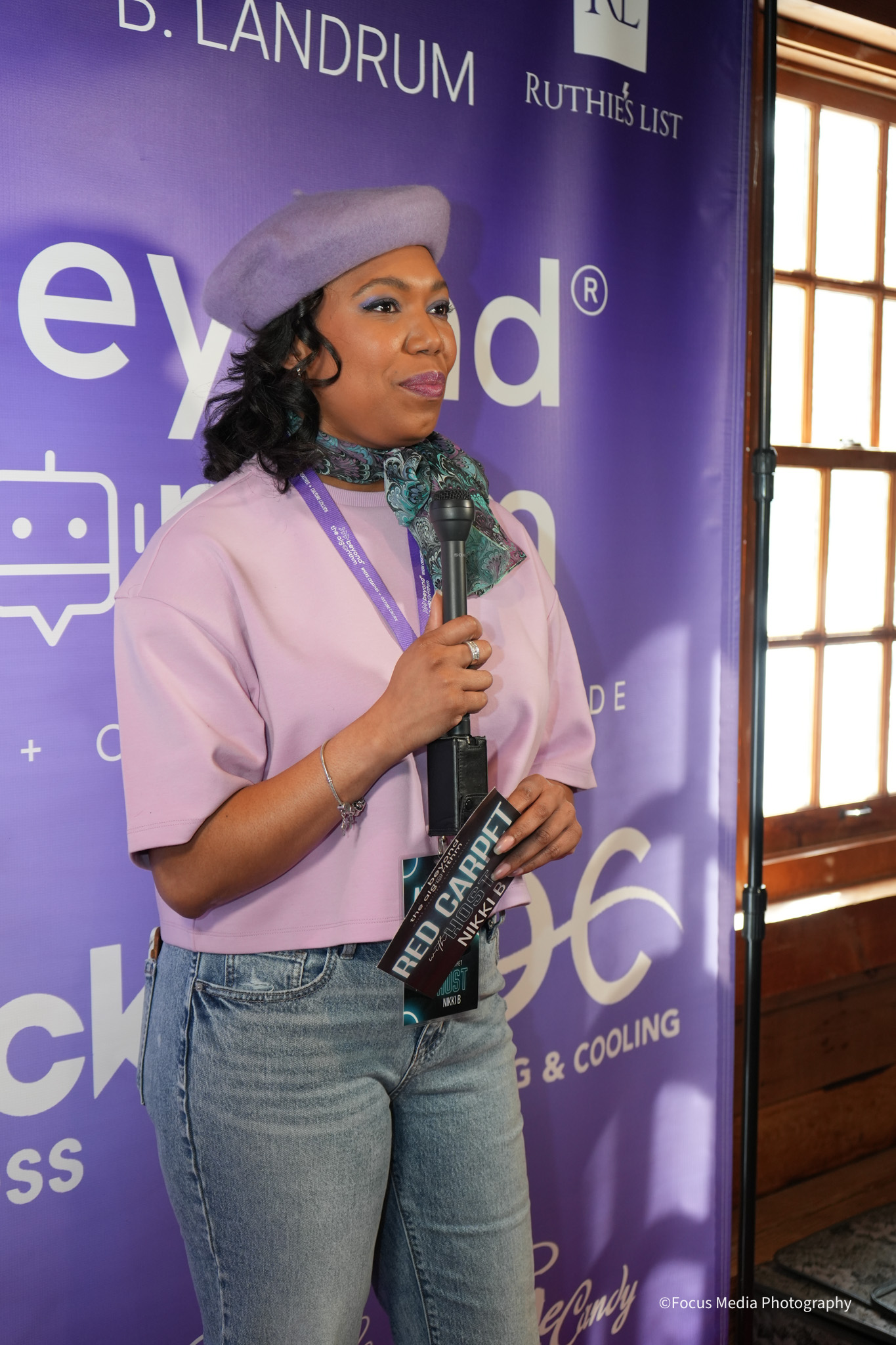 Nikki B speaking on the mic at the Beyond the Algorithm Powerbrand event